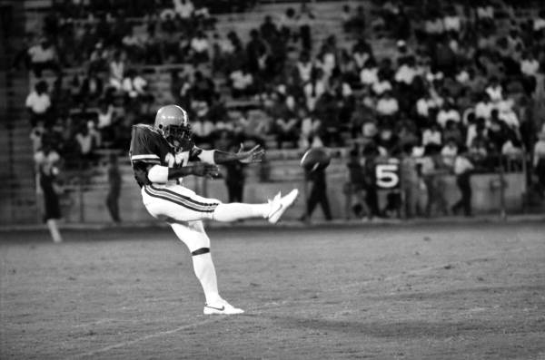 FAMU football player kicks the ball at FAMU vs Trojans football game - Tallahassee, Florida.