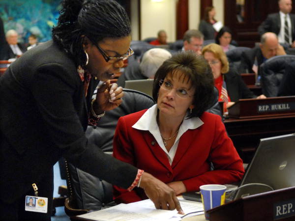 Representatives Audrey Gibson, D-Jacksonville, left, and Denise Grimsley, R-Sebring, conferring on the House floor during the legislative session in Tallahassee, Florida.