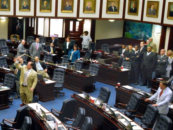 Florida State Representative Baxter Troutman, R-Winter Haven, demonstrating the cracking sound of a bull whip during "Boot Day" activities on the House floor in Tallahassee, Florida.
