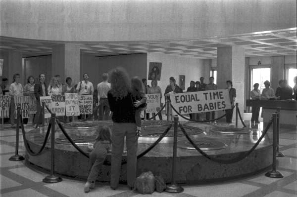 Mother and children observe the Pro-Life protestors - Tallahassee, Florida