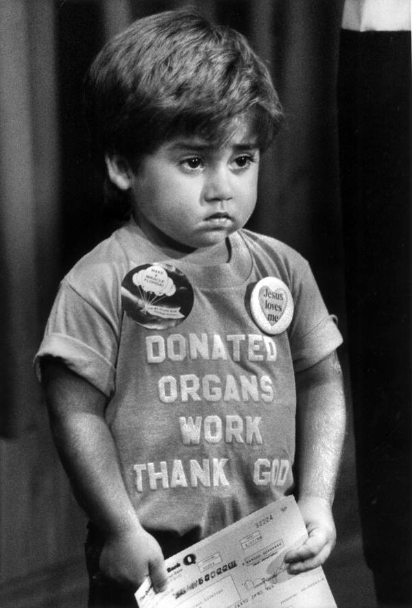 Johnny Steffen holds a donation check during a news conference - Tallahassee, Florida .