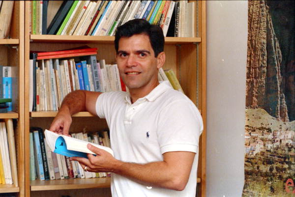 Author Roberto Fernandez poses with his books - Tallahassee, Florida