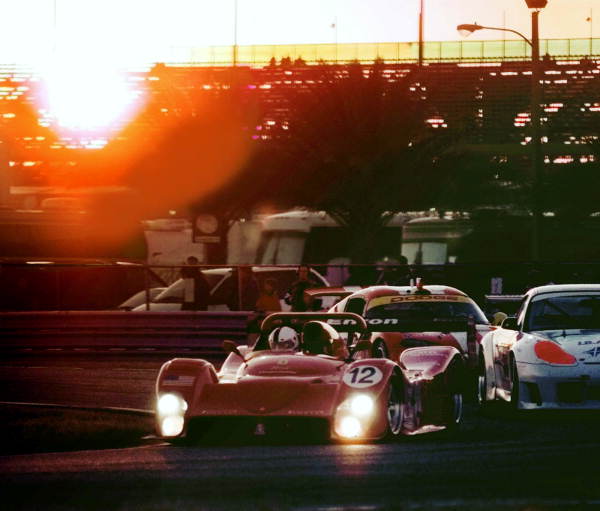 Cars running the Rolex 24 endurance race at sunset - Daytona Beach, Florida
