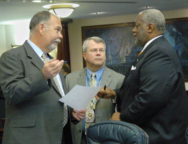 Rep. Will Kendrick, D-Carrabelle, left confers with Rep. Wilbert Holloway, D-Miami Gardens, right, on the House floor - Tallahassee, Florida .