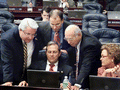 Members huddled around Florida State Representative Paige Kreegel during a short break on the House floor in Tallahassee.