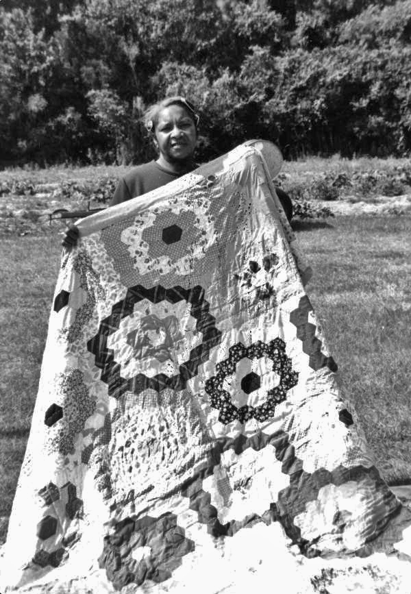 Betsy (Mrs. Denard) Webb with one of her quilts in White Springs, Florida.