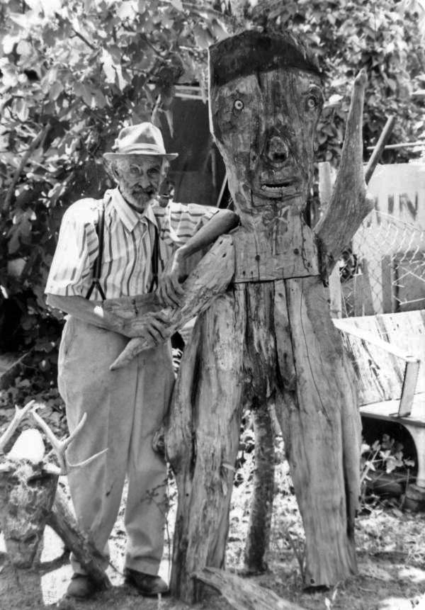 Sculptor Jesse J. Aaron standing with one of his works in Gainesville, Florida.