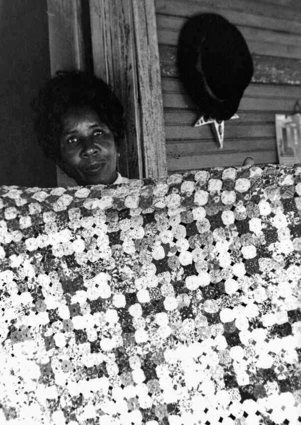 Portrait of Queenie Udell with one of her yo-yo quilts in White Springs, Florida.