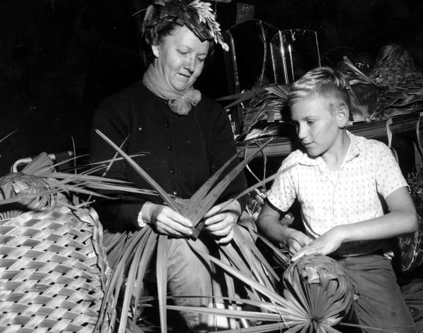 Evelyn C. Parks demonstrating palmetto weaving to a young boy at the Florida Folk Festival in White Springs, Florida.