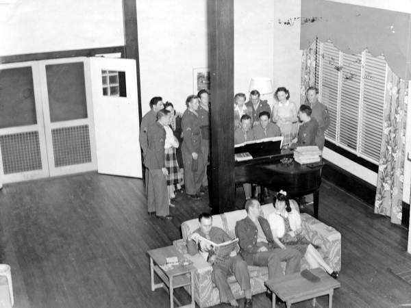 View showing servicemen gathered around piano at the Gainesville Recreation Department's Service Center.