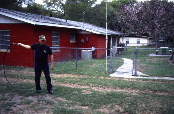 Whipmaker Ernest "Shelby" Braddock cracking one of the handmade cow whips at his home in De Land, Florida.