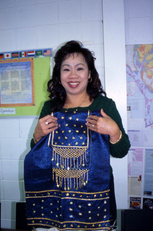 Kham Insouta (teacher) showing a piece of Lao dance costume at the Asian Neighborhood Center in St. Petersburg, Florida.