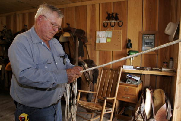 Unidentified whipmaker braiding a new whip.