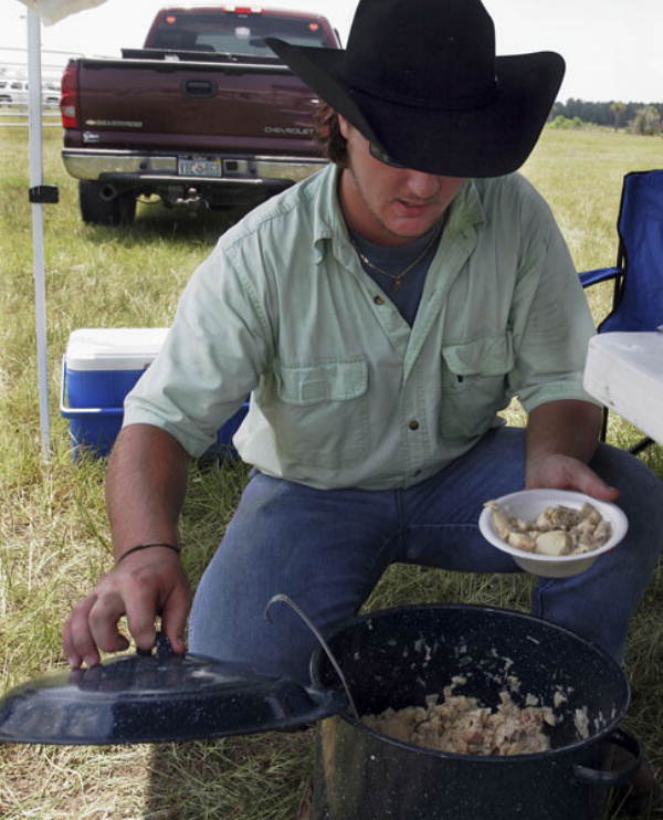 Cowboy getting some food during the Okee Ranch rodeo.