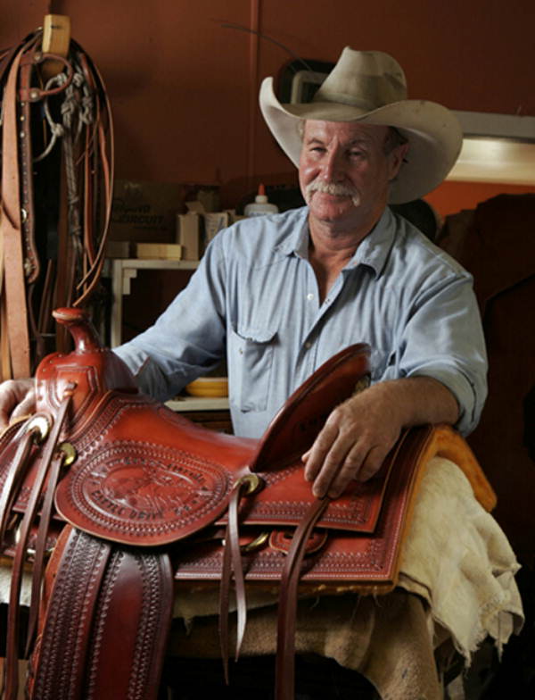Portrait of Mike Wilder with saddle in Florida.