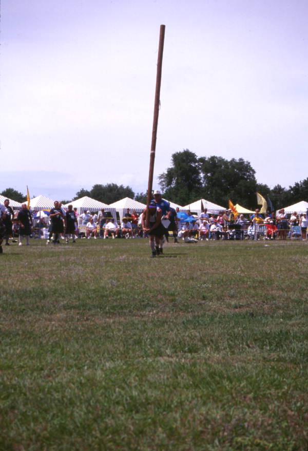 Man in the process of "turning the caber" during the Highland Games in Dunedin, Florida.