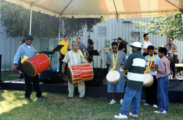View showing the Indo-Trinidadian tassa drumming group "Romeo and the Boys" performing at the Historical Museum of Southern Florida's Harvest Festival in Miami, Florida.