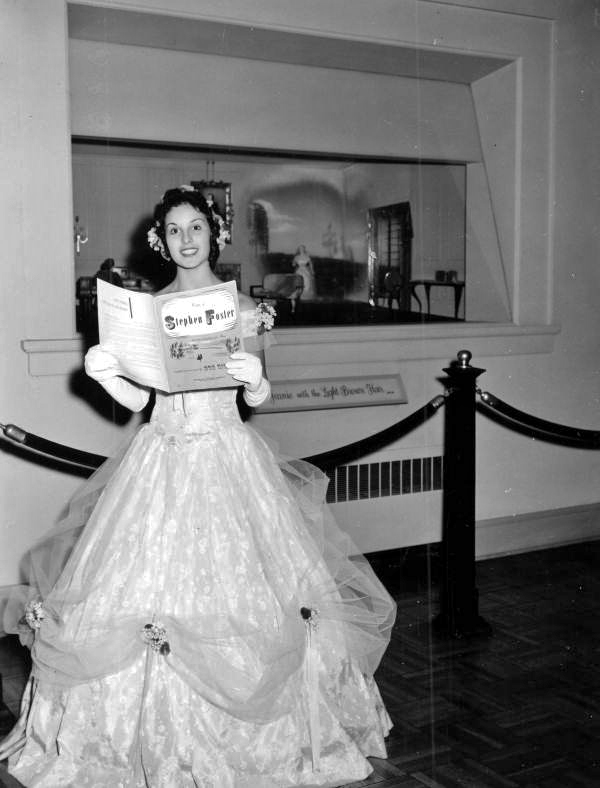Rebecca Ann Jenkins reading from a Stephen Foster booklet at the Jeanie Diorama- White Springs, Florida