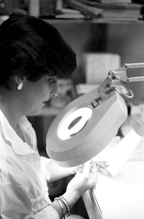 Maria Marulanda making cuts in parchment during cardmaking - Miami, Florida.