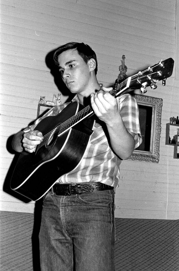 Frank Trivette Jr. playing rhythm guitar during bluegrass session - East Palatka, Florida