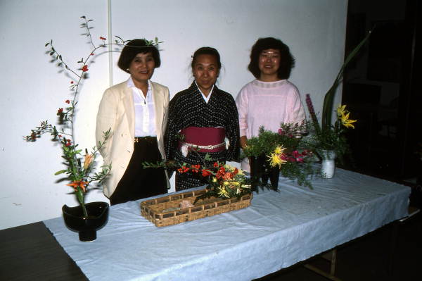 Sumino McGlamory (L), Atsuko Lefcourte, and Kathy Leventhal (R) stand with their Ikebana floral arrangements- Lake Park, Florida.