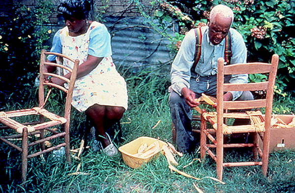 Rufus Adams and step-daughter Annie Sellers making corn shuck chairs
