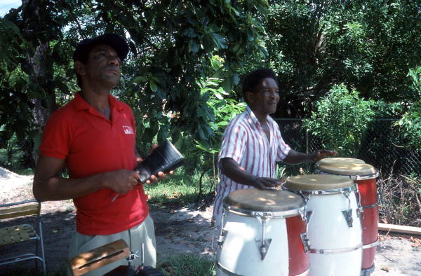 Florencio Baro playing the conga drum while his apprentice Marcial Hernandez accompanies on the "cow bell"