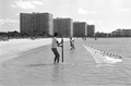 Two boys pulling in a cast net they are fishing with