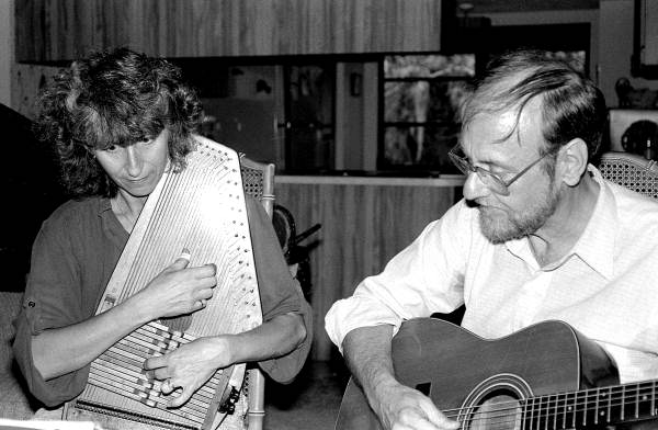 Autoharp player Charley Groth (playing guitar) teaching apprentice Cheryl Belanger how to play the instrument- Crystal Beach, Florida