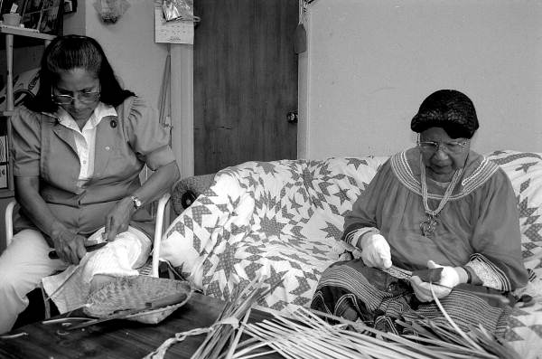 Marian Bowers and her apprentice Martha Jones making palmetto stem baskets - Brighton Seminole Indian Reservation, Florida.