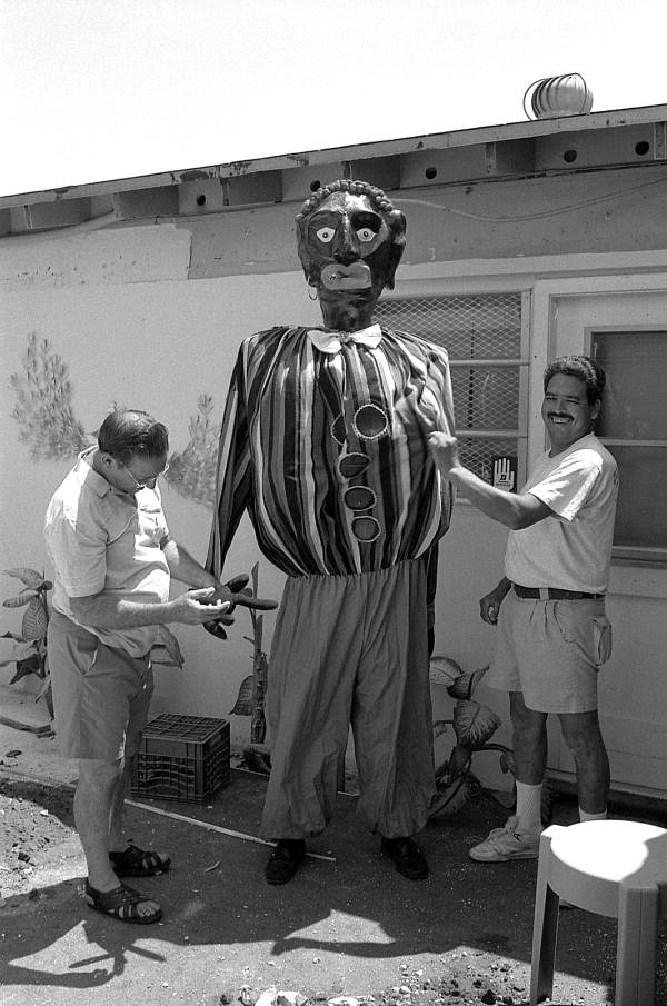 Isaac Duenas (L) and apprentice Ramon Zepeda putting finishing touches on a gigante to be used in festival - North Miami Beach, Florida.
