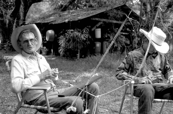 Cow whip maker George "Junior" Mills (l) and his apprentice J. Taylor Marcus making whips - Okeechobee, Florida.