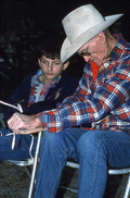 Cow whip maker George "Junior" Mills (r) working as his apprentice J. Taylor Marcus looks on - Okeechobee, Florida.