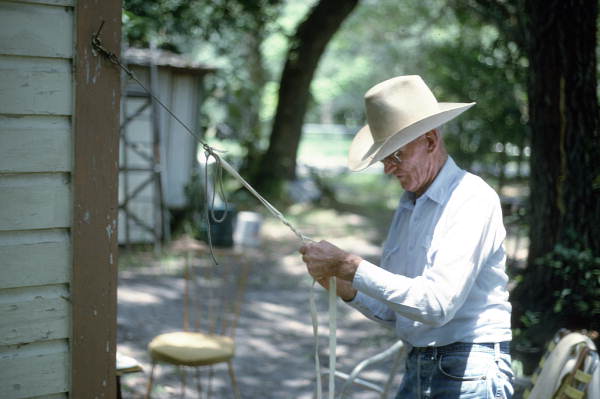 Cow whip maker George "Junior" Mills plaiting a whip - Okeechobee, Florida.