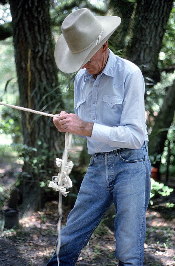 Cow whip maker George "Junior" Mills braiding a whip - Okeechobee, Florida.