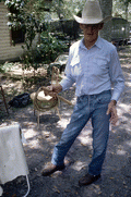 Cow whip maker George "Junior" Mills holding whip - Okeechobee, Florida.