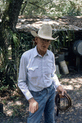 Cow whip maker George "Junior" Mills holding whip - Okeechobee, Florida.