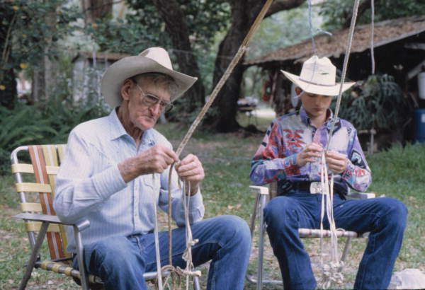 Whip maker George "Junior" Mills describing the plaiting of cow whips to his apprentice - Okeechobee, Florida.