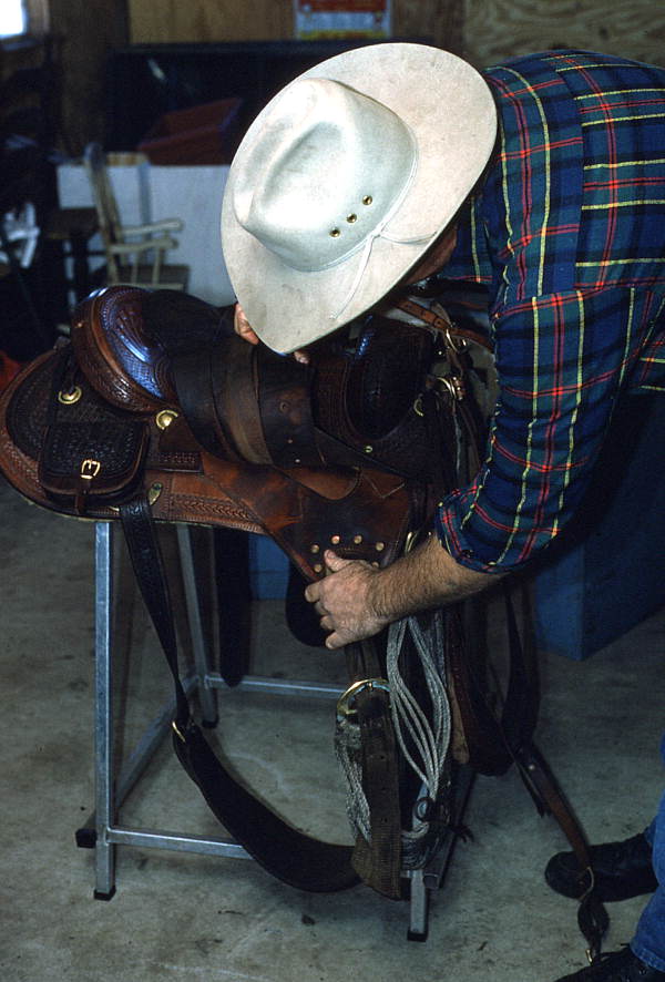 Saddlemaker Mike Wilder inspecting a saddle - Kenansville, Florida