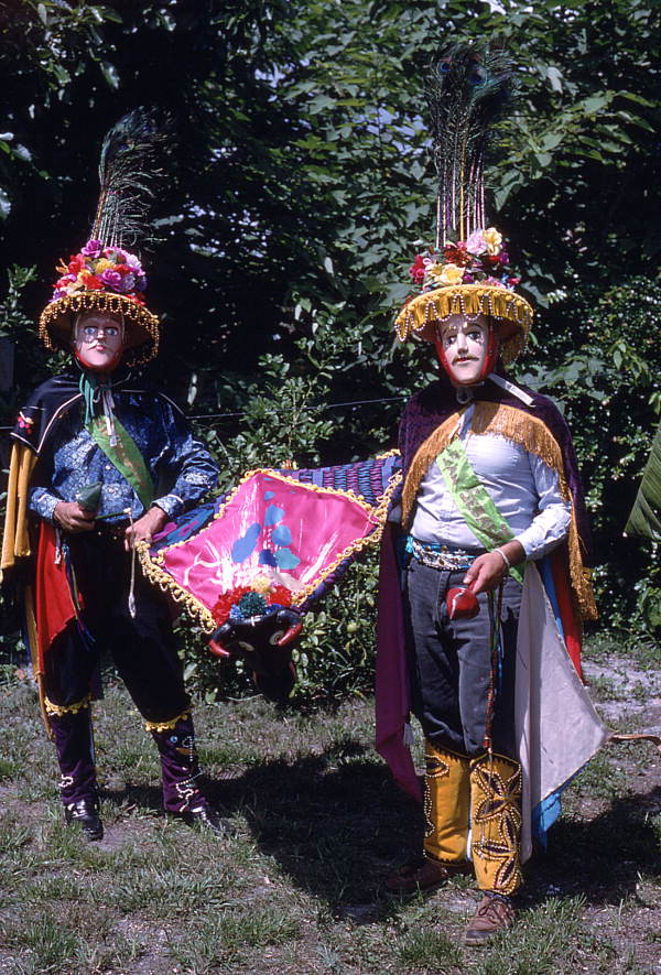 Jose Silva, right, and his apprentice Marvin Silva wearing the mandador costumes and holding the bull mask of the Nicaraguan Toro Huaco pageant.