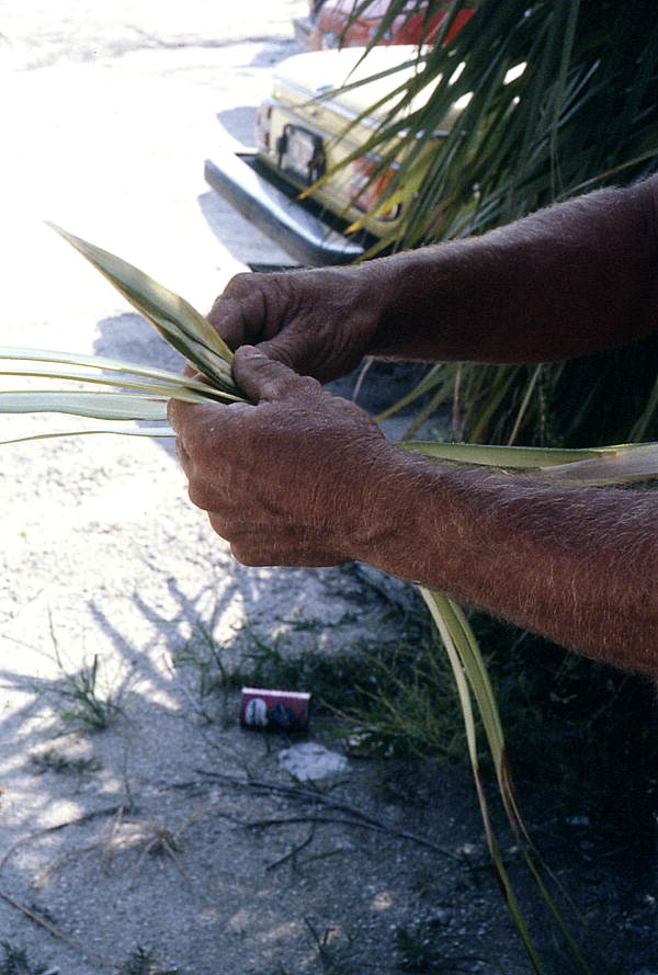 Palm frond hat maker Vic Simmons weaving a bird - Boynton Beach, Florida.
