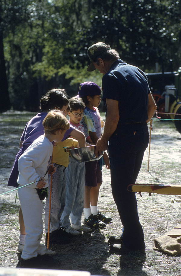 Lee Erixton showing corn meal at corn grinding demonstration - White Springs, Florida