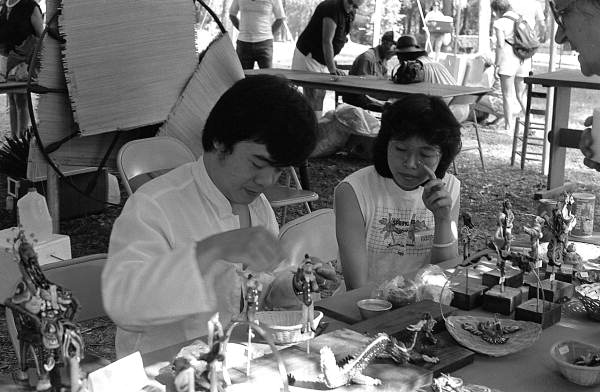 Fu Yung Chang of Gainesville, left, demonstrating rice dough figure making at the 1986 Florida Folk Festival - White Springs, Florida