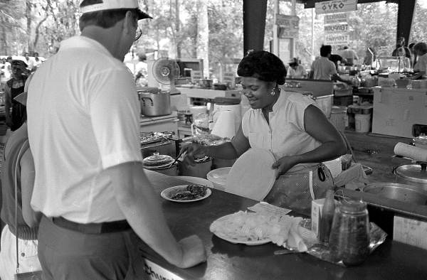 Woman serving food at the Beulah Baptist Church food booth at the 1987 Florida Folk Festival - White Springs, Florida