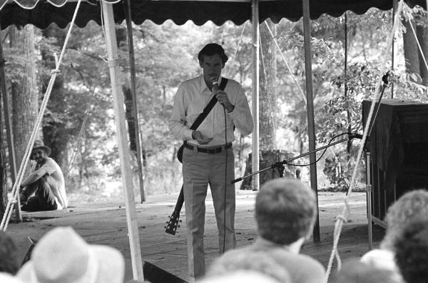 Storyteller and musician Gamble Rogers speaking to audience at the 1987 Florida Folk Festival - White Springs, Florida
