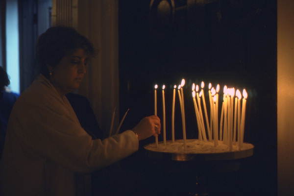 Lighting candles at St. Nicholas Cathedral during Epiphany Day services - Tarpon Springs, Florida