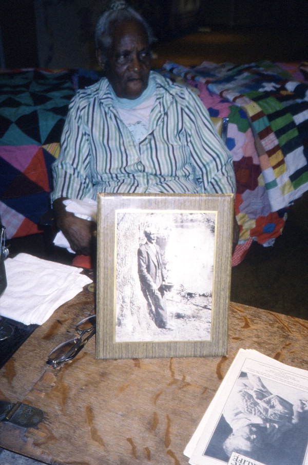 Quilter Sally Jones holding photograph of her grandfather - White Springs, Florida