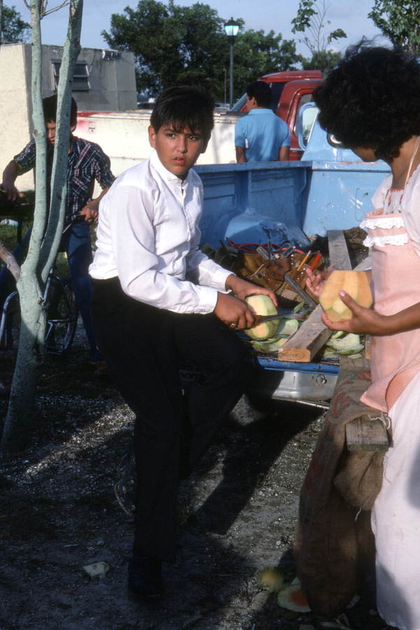 Cruz family members preparing fruit at Mexican Independence Day celebration - Florida City, Florida.