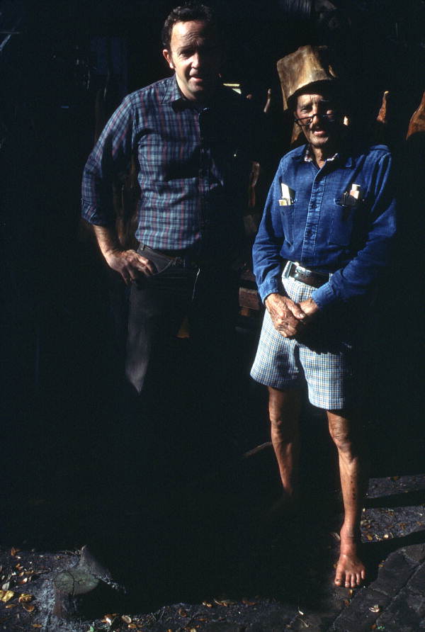 Portrait of Tom Gaskins wearing his cypress knee cap with an unidentified tourist - Palmdale, Florida.