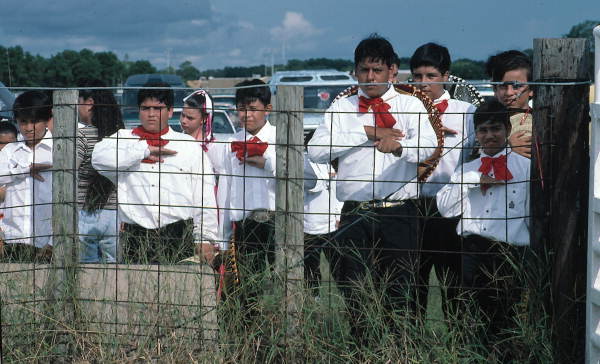 Male Dancers peer through a fence - Pierson, Florida